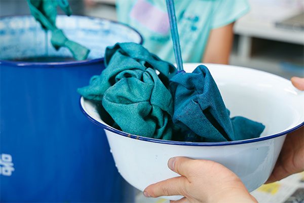 無地のトートバッグを蓼藍（タデアイ）から抽出した染料で染めていきます。